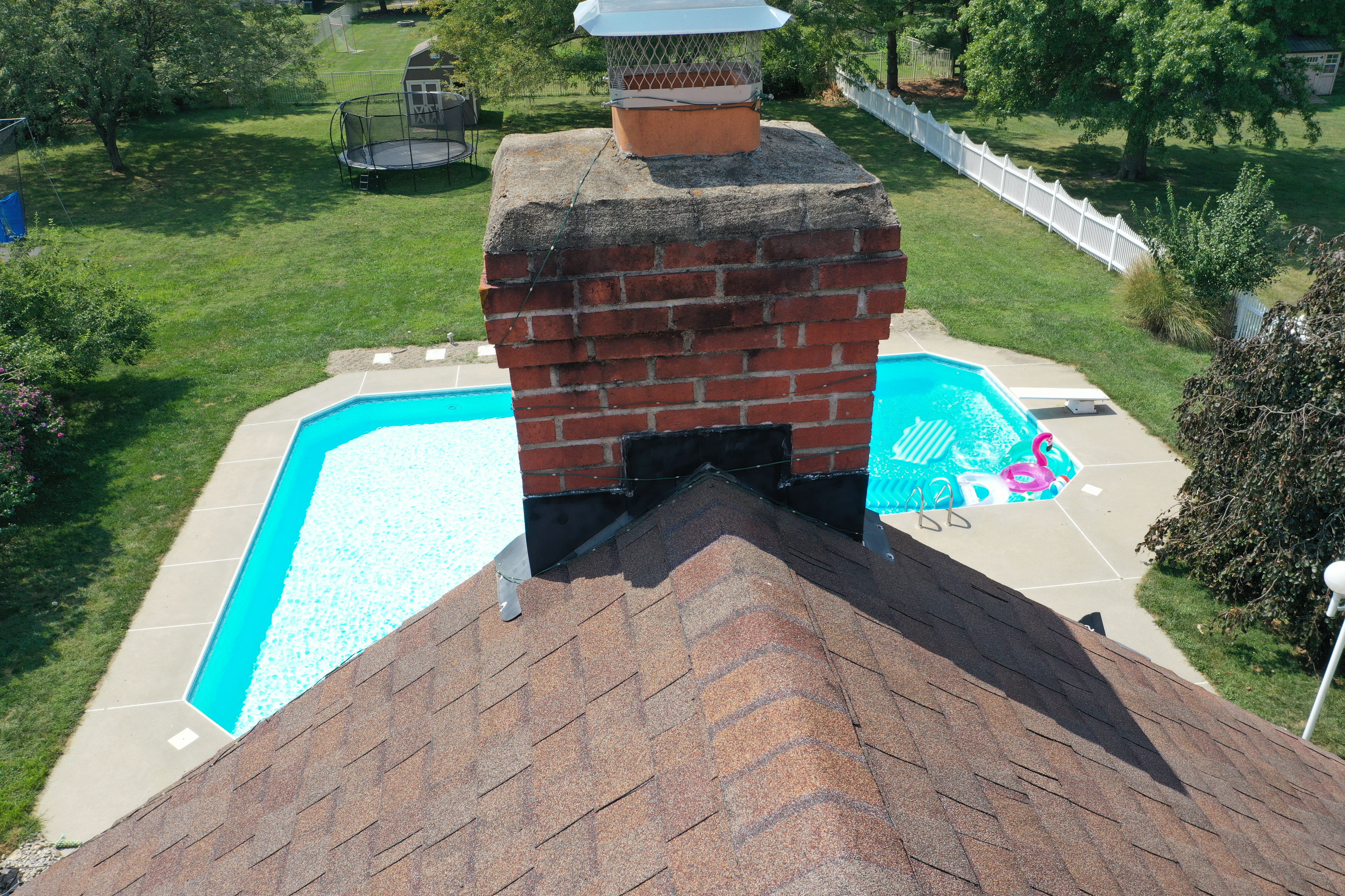 Flashing Detail - Chimney penetration showing aerial view of brick chimney and roof flashing