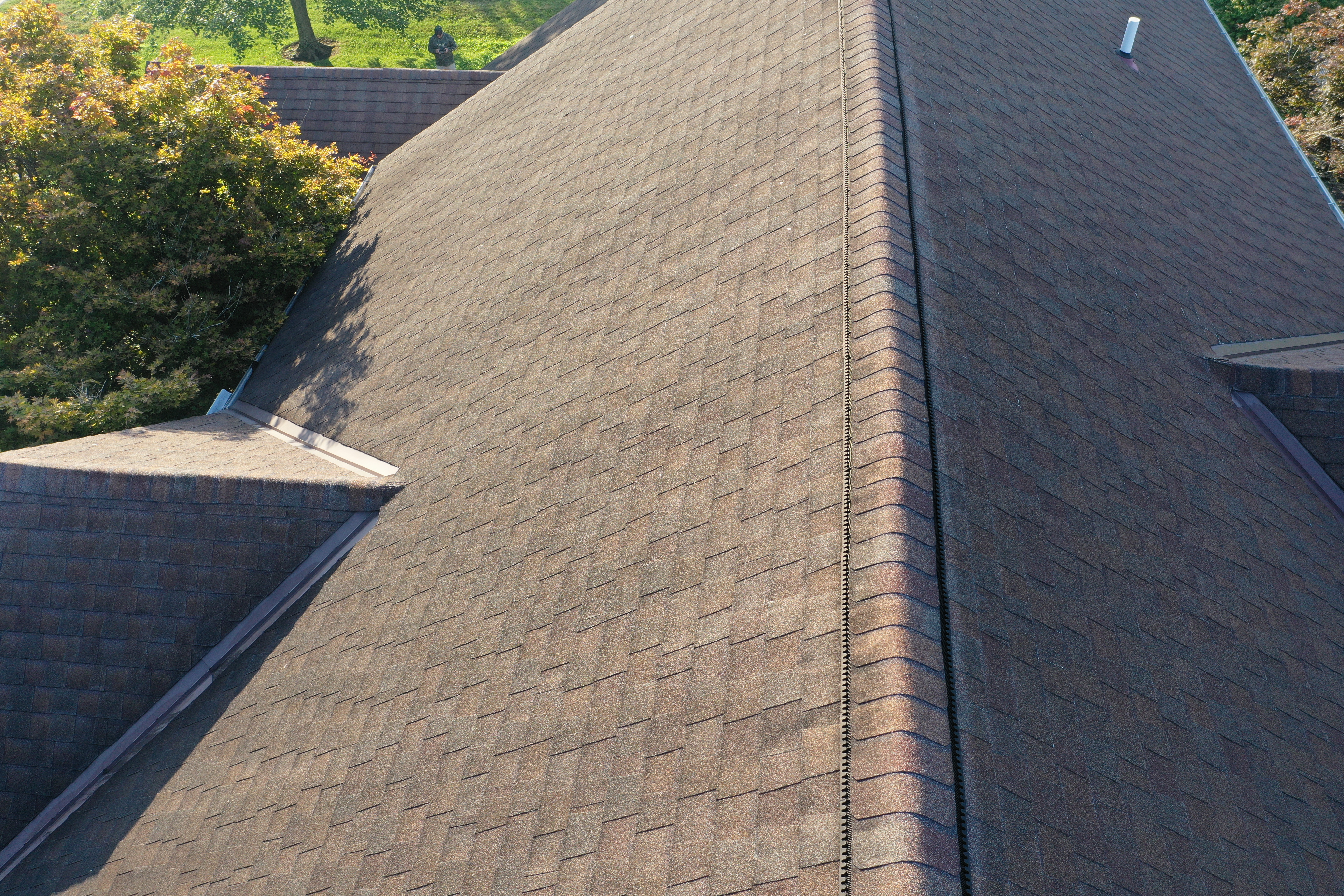Ventilation - Ridge & soffit vents showing detailed aerial view of ridge cap and shingle condition